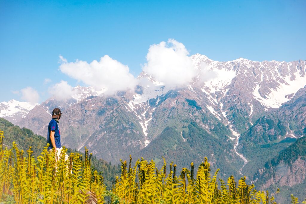 Man gazing at majestic mountain landscape.